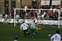 16 ...the keeper spreads himself and gets a foot to  the ball to force it out.jpg