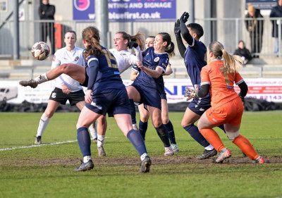 2024-25 v Bromley KWC qtr-fin Xayla challenges goalmouth scramble.jpg
